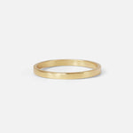 Angled view of the Flat Band / 2mm Customizable in 14k yellow gold