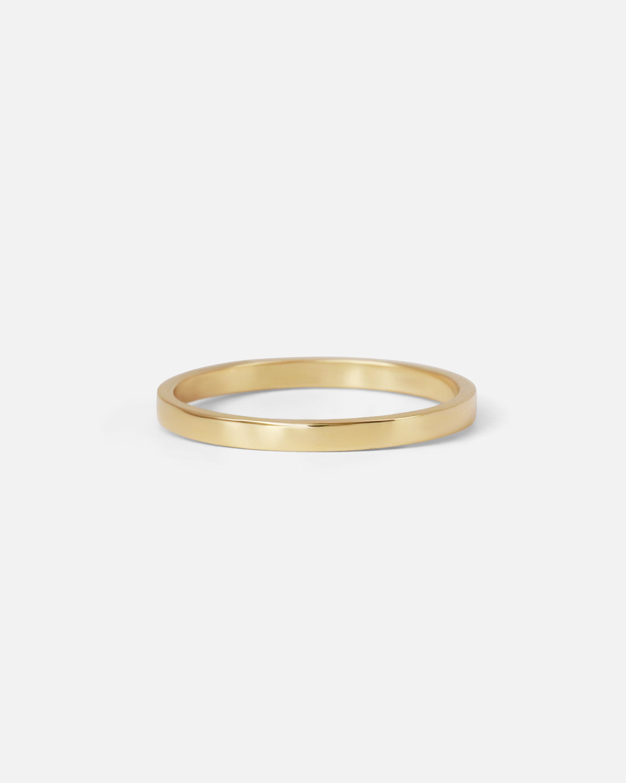 Angled view of the Flat Band / 2mm Customizable in 14k yellow gold