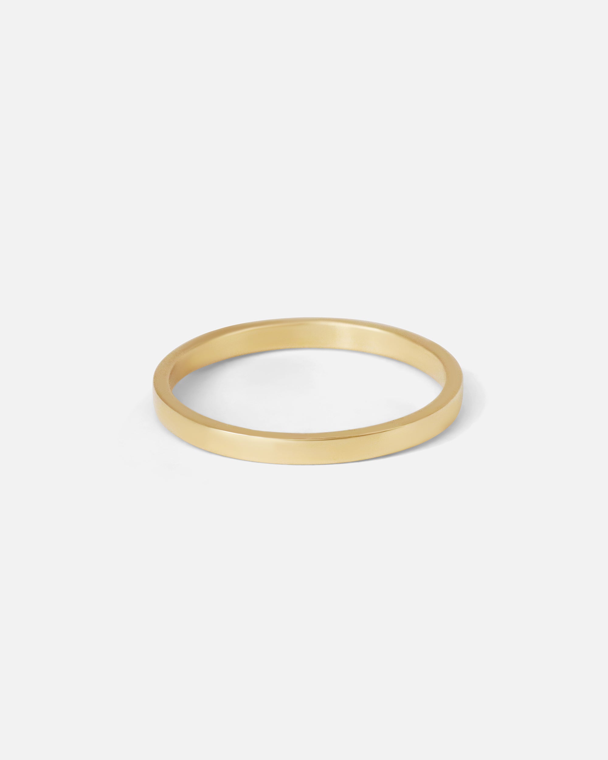 Angled view of Flat Band / 2mm Customizable in 14k yellow gold