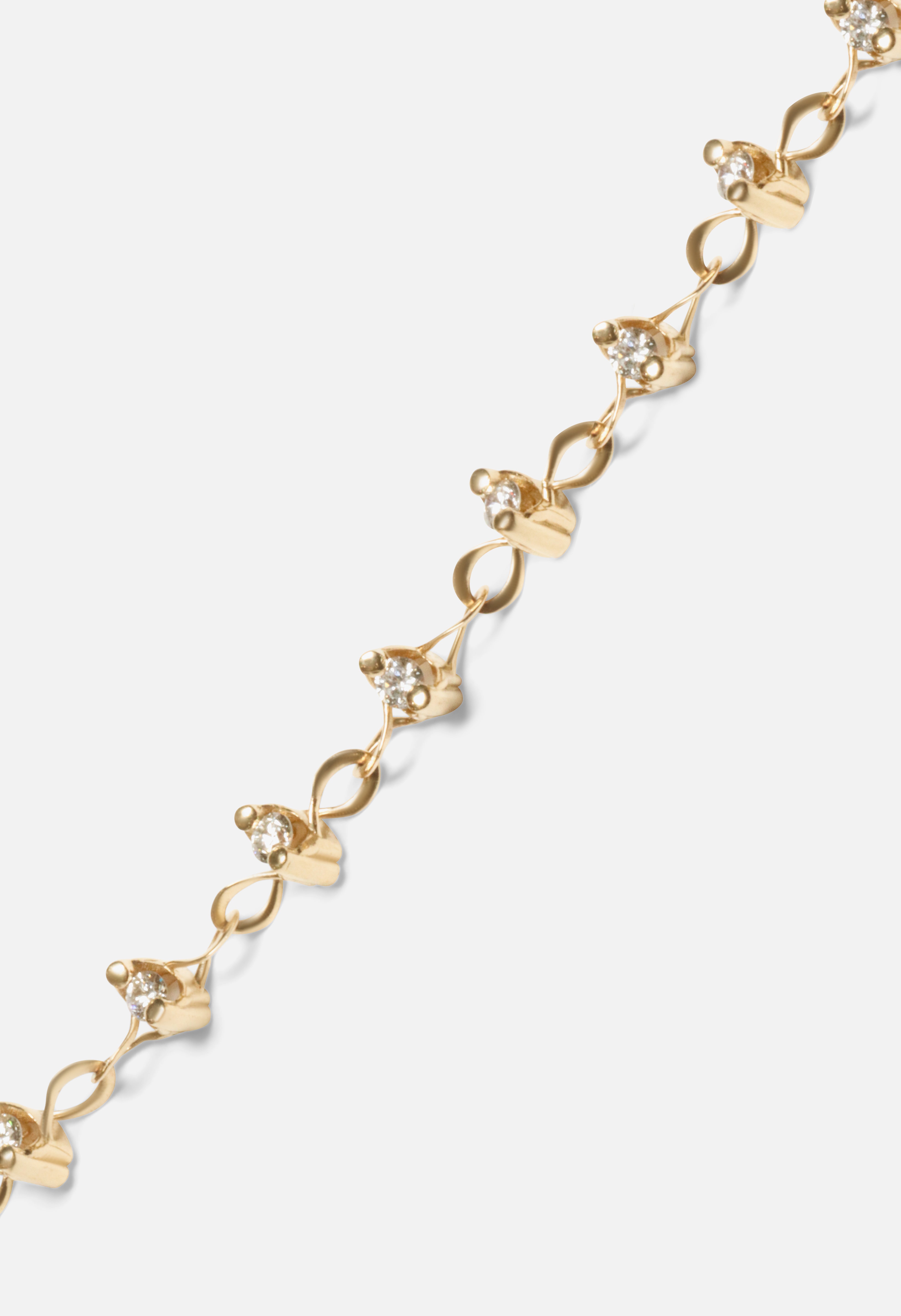 Close up view of Locus Intermittendi Bracelet	in 14k yellow gold by Lucia B Marti