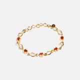 Side view of Nucleus Intermittendi Bracelet / Ruby in 14k yellow gold by Lucia B Marti