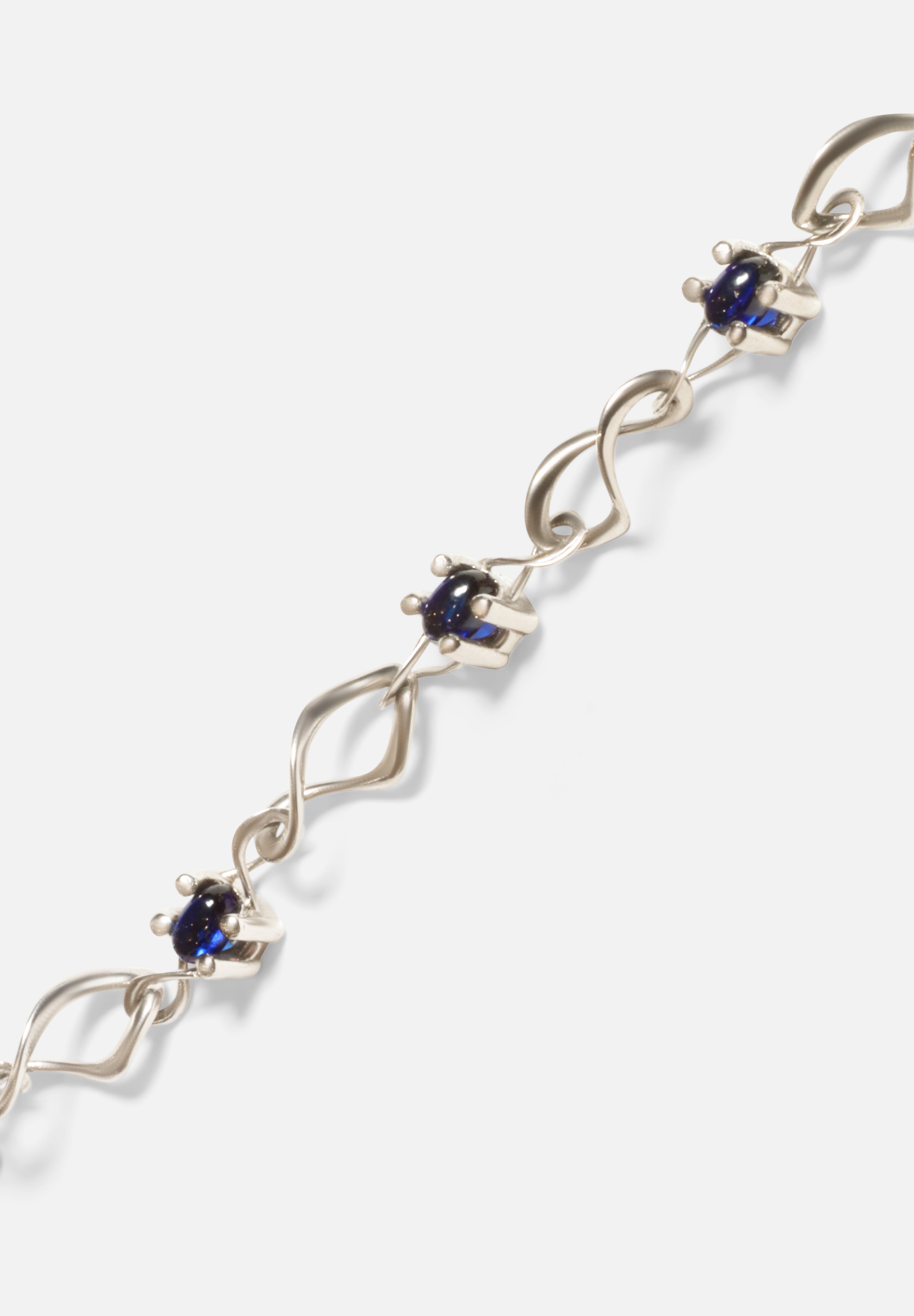 Close up view of Nucleus Intermittendi Bracelet / Sapphire in 14k white gold by Lucia B Marti