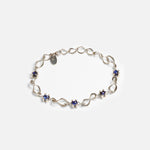 Front view of Nucleus Intermittendi Bracelet / Sapphire in 14k white gold by Lucia B Marti