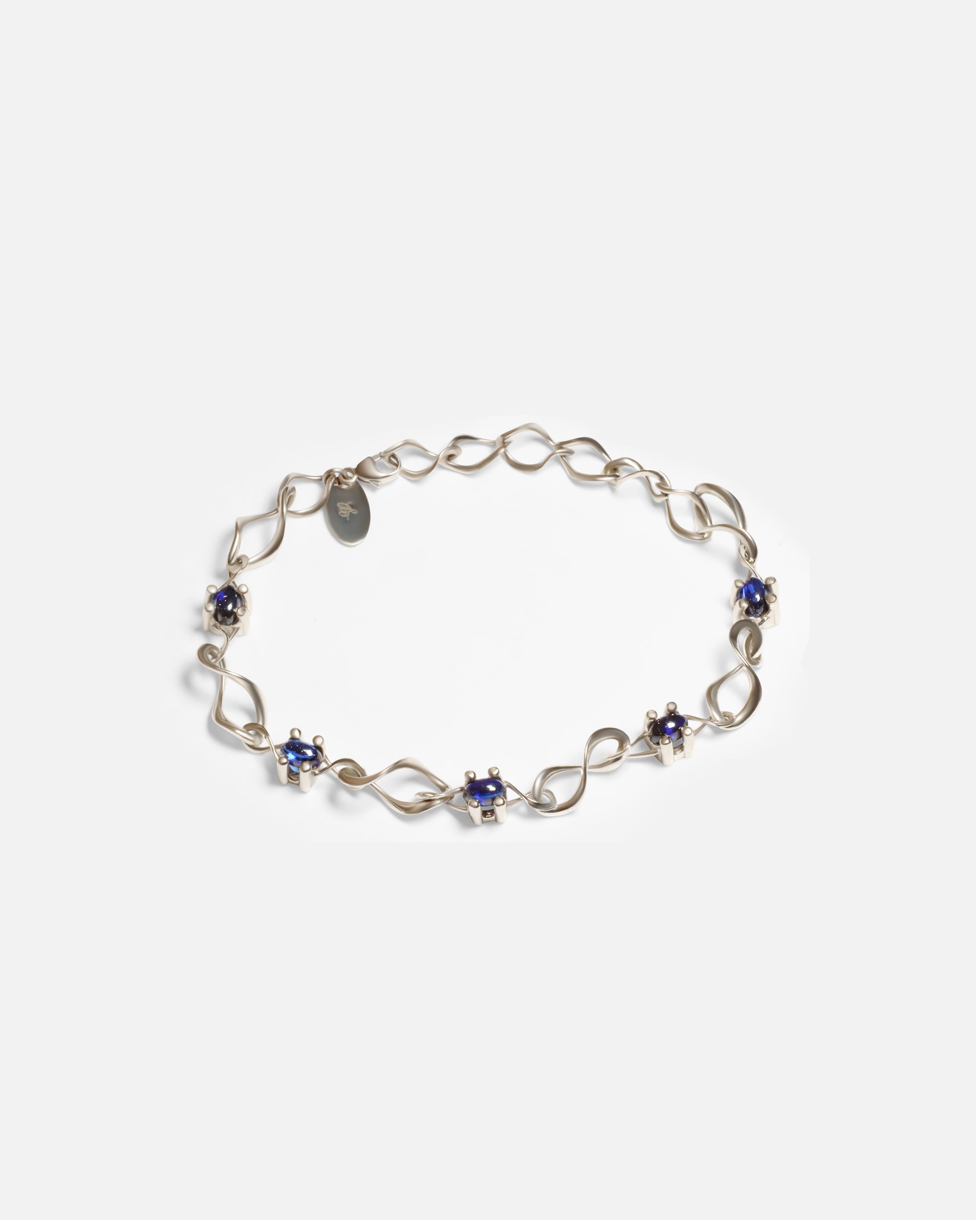 Front view of Nucleus Intermittendi Bracelet / Sapphire in 14k white gold by Lucia B Marti