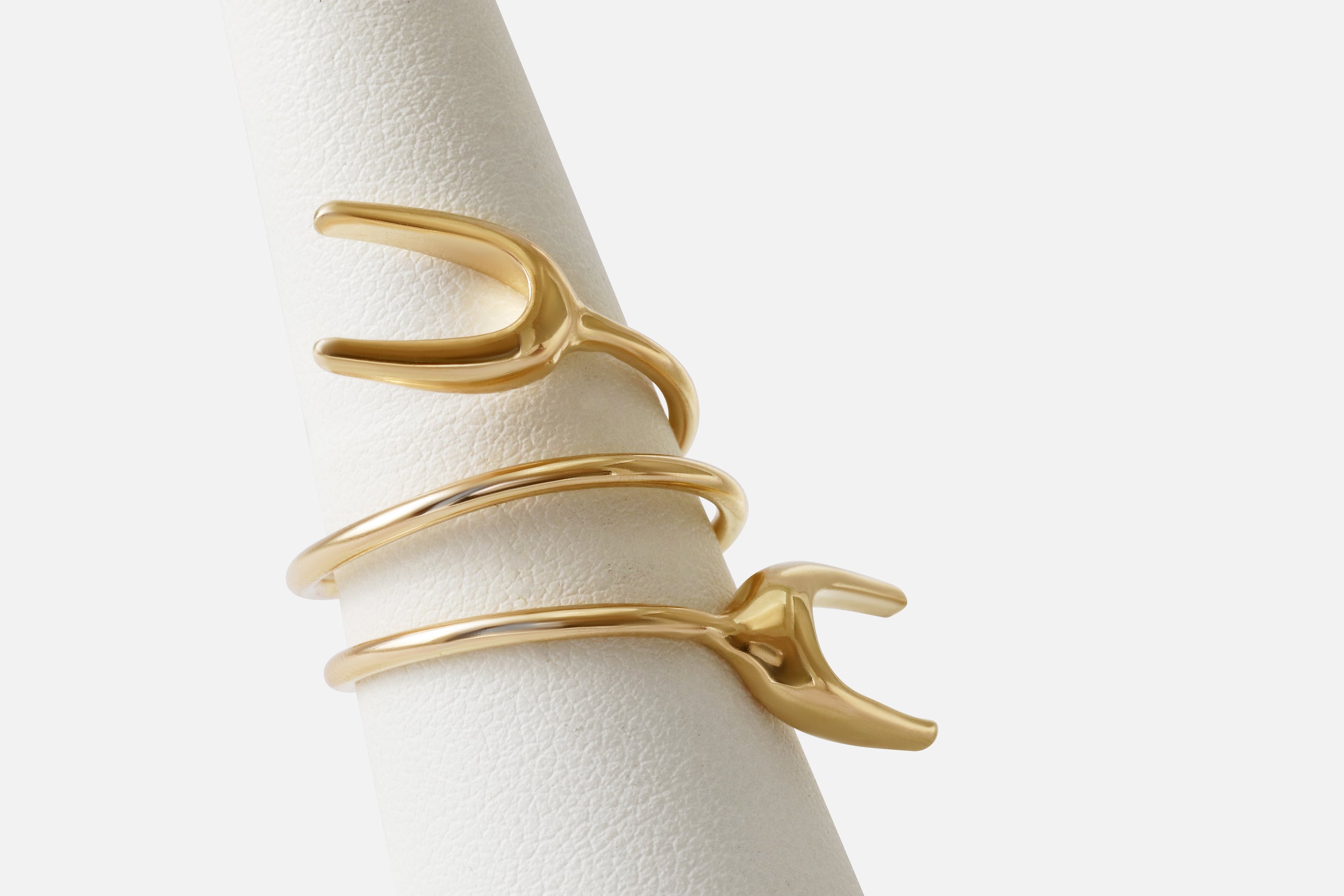 Angled view of Double X Ring By Lucia B Marti on stand