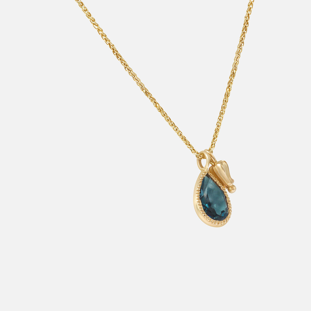 Side view of Little Mirror and Topaz Pendant