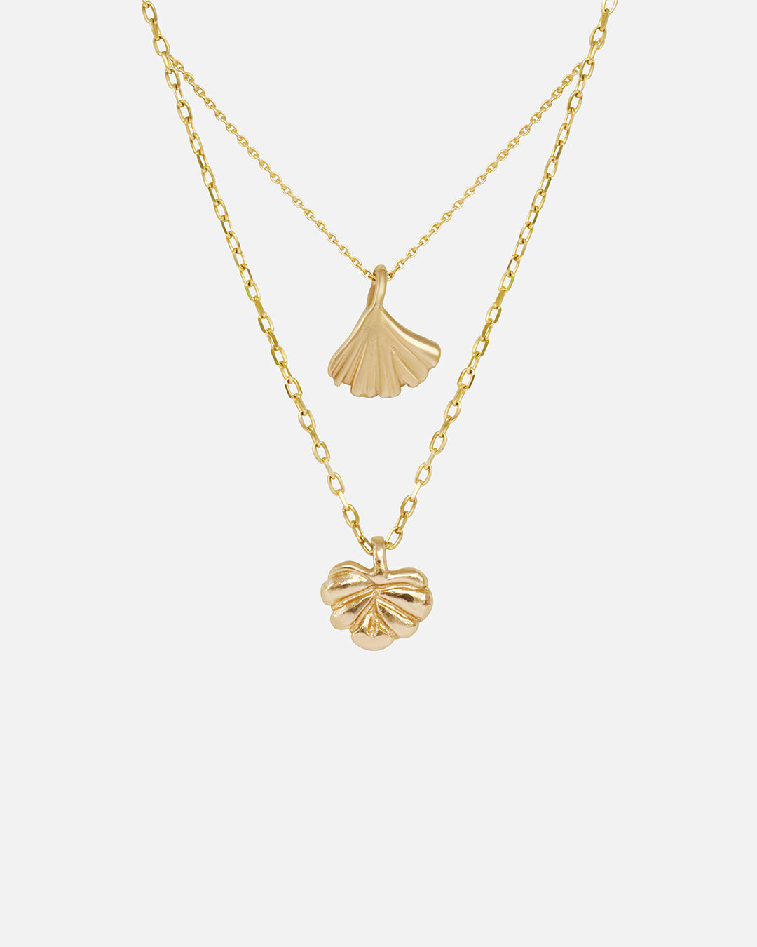 Front view of Ginkgo Necklace in 14k yellow gold and Lotus Necklace in 14k yellow gold hanging together