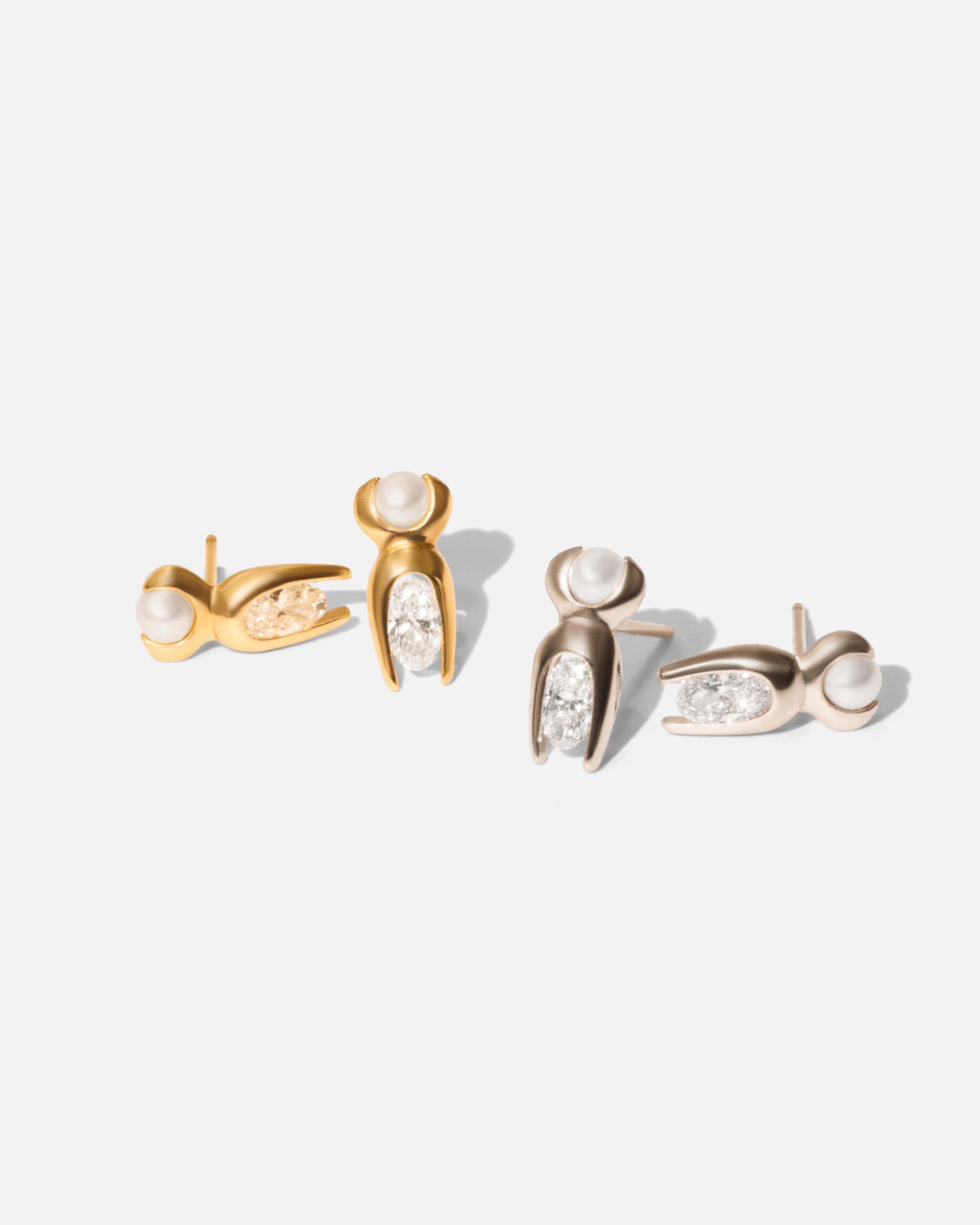 Group shot of Mutation Earrings in 14k yellow gold and 14k white gold by Lucia B Marti